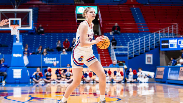 Kansas Jayhawks guard Zsofia Telegdy looks to pass against the Oklahoma State Cowgirls